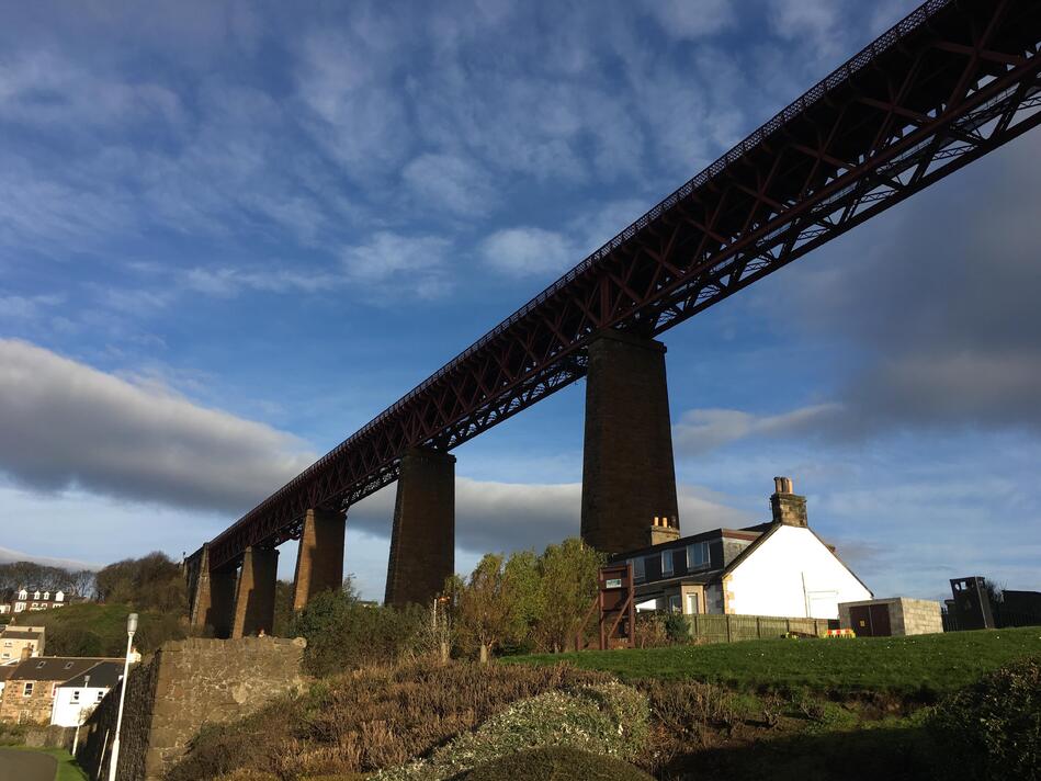 The bridge running across the image, with a few houses visible along the ground.